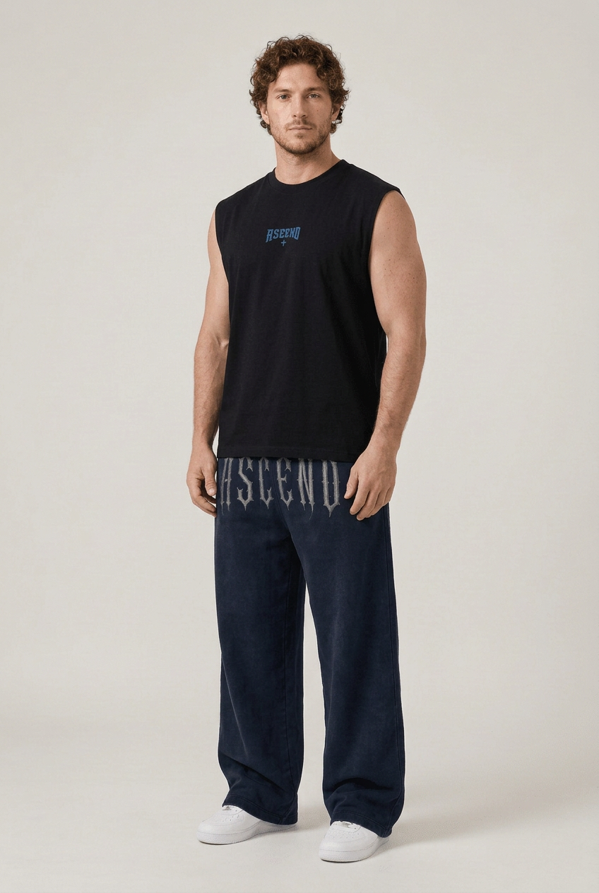 Male three-quarter front view wearing black ASCEND tank and navy ETERNAL ASCEND joggers